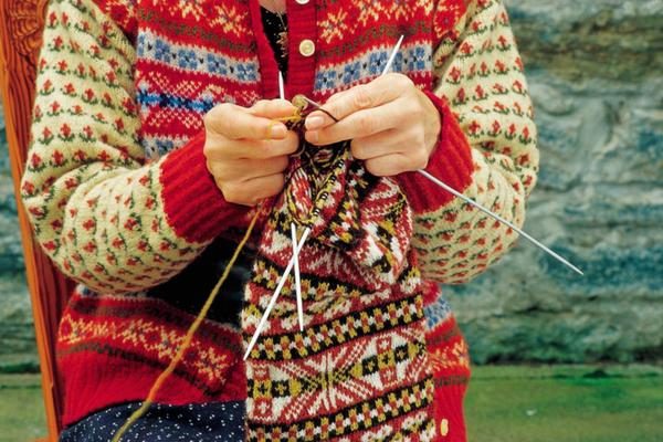 A woman knitting at the Shetland Textile Museum at Weisdale Mill