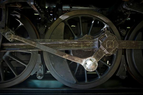 A close up of the wheels of a locomotive at the Riverside Museum in Glasgow